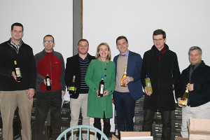 Clas (third from the right) with the Cellar Fine Wines team at their Essex, CT warehouse holding bottles of Curious Cork brands including Tuscan Sun Wines, Baracchi Winery and Faire la Fête. From left to right: CFW Hartford County Sales Representative Jake Ruder; CFW Regional Account Manager Rich Veilleux; CFW New Haven County Sales Representative Dan Reynolds; CFW Portfolio Manager Jillian Simms; Clas; CFW Fairfield County Sales Representative Jeff Schultz; and CFW Business Development Director George Carabetta.