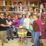 Craig Fowler, Partner, Brooklyn Wine and Spirits and Irene Tan, Owner, Brooklyn Wine and Spirits, presenting the check donation to Jean Cyr, Director of Food Pantry; Laura Kroll, Executive Assistant, Food Pantry; Pauline Millette, Assistant Director, Food Pantry; Molly Truesdale, Friends of Assisi Volunteer.