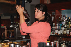 Jen Davis, United States Bartenders Guild Rhode Island (USBG RI) Chapter Member and Bartender at The Eddy, mixing cocktails.