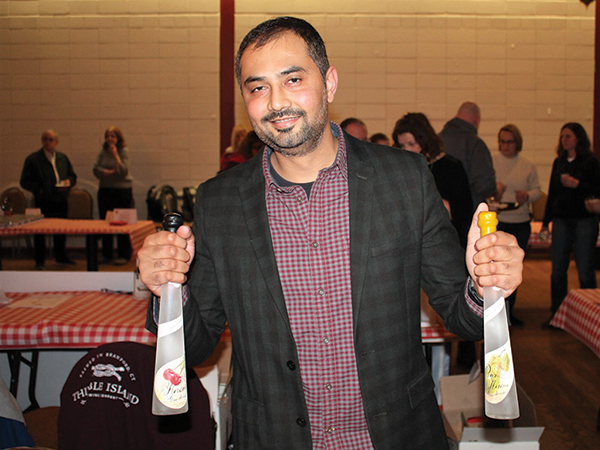 Sunny Rajvansh, Sales Representative, Slocum & Sons, pouring fruit brandy and eau de vie selections made by Westford Hill Distillers in Ashford.