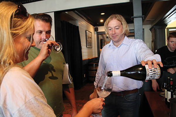 Matt Barcewicz, Connecticut Sales Representative, Michael Skurnik Wines, pouring a sample for Christopher and Melissa Jeans of Casa Bacchus Wine Shoppe in Litchfield.
