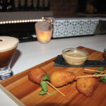 A cocktail and menu pairing, “Maple Bourbon Espresso” with Kobe beef corn dog bites.