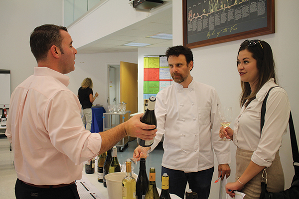 Mike Tobin, Worldwide Wines, talking with Rory Germain, Worldwide Wines, and Aui Szapiro, Roia Restaurant. 