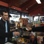 Holod pouring a sample of wine for Ryan Silverbrook of Silverbrook Wine and Liquor in Orange.