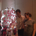 Abbie Kundishora, Sales and Promotions Manager, Bom Bom Brands, with a guest using the Bom Bom Brands ice luge.