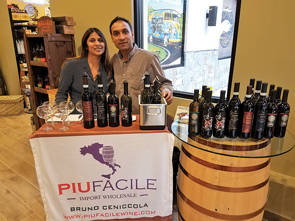Owners Varsha and Prashant Mehta of Cork & Barrel in Hamden providing tastes of Piu Facile wines. 