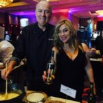 Chef Ihsan Gurdal and Donna Taylor pouring wine selections. Gurdal featured farmhouse cheeses paired with artisanal condiments and Alpine fondue during the Celebrity Chef Dine Around on Saturday night.