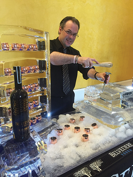 Bartender Anthony DeSerio hand carving ice for the cocktails.